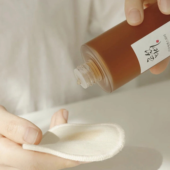 model applying Beauty of Joseon Ginseng Essence Water on a pad