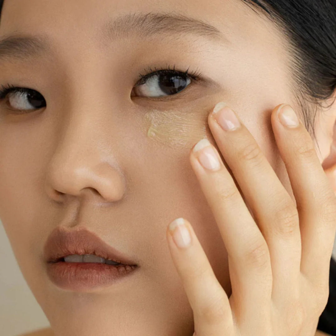 model applying Beauty of Joseon Revive Eye Serum Ginseng + Retinal around eyes