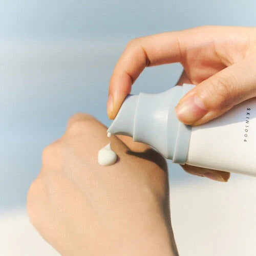 model applying SKIN1004 Madagascar Centella Hyalu-Cica Water-Fit Sun Serum SPF50+ PA++++