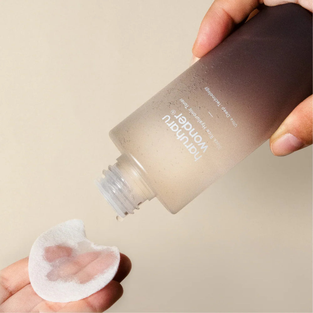 Close up view of the essence-like texture of the Black Rice Hyaluronic Toner on a pad