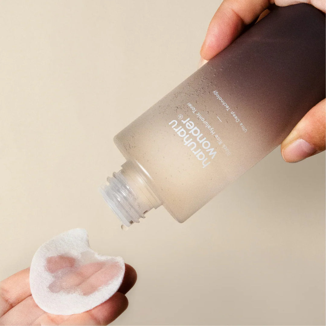 Close up view of the essence-like texture of the Black Rice Hyaluronic Toner on a pad