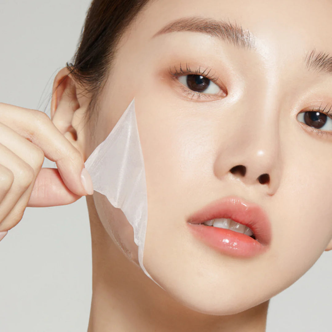 model applying Medicube Collagen Night Wrapping Mask on face before sleep