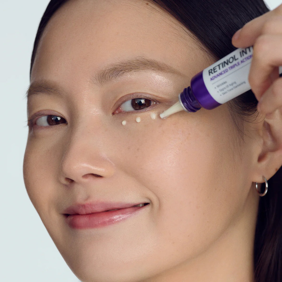 model applying SOME BY MI Retinol Intense Advanced Eye Cream under eyes